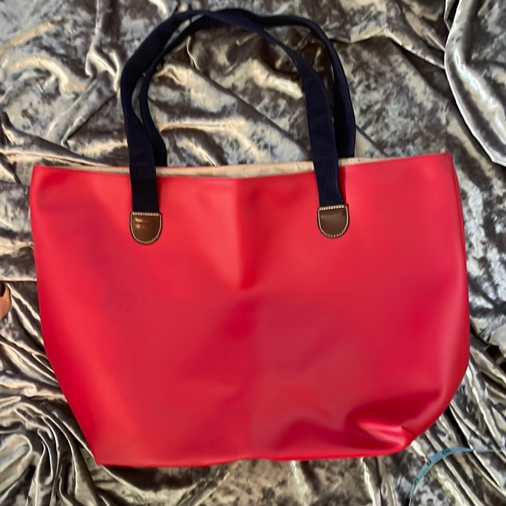 Large red leather tote with heavy navy handles and nylon fabric lining